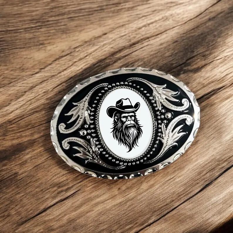 Bigfoot Belt Buckle Cowboy Accessory Western on a rustic wooden table