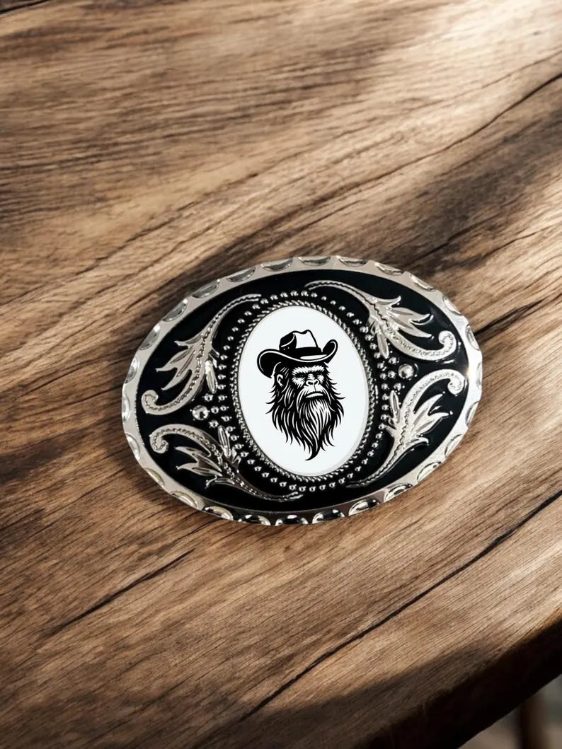 Bigfoot Belt Buckle Cowboy Accessory Western on a rustic wooden table