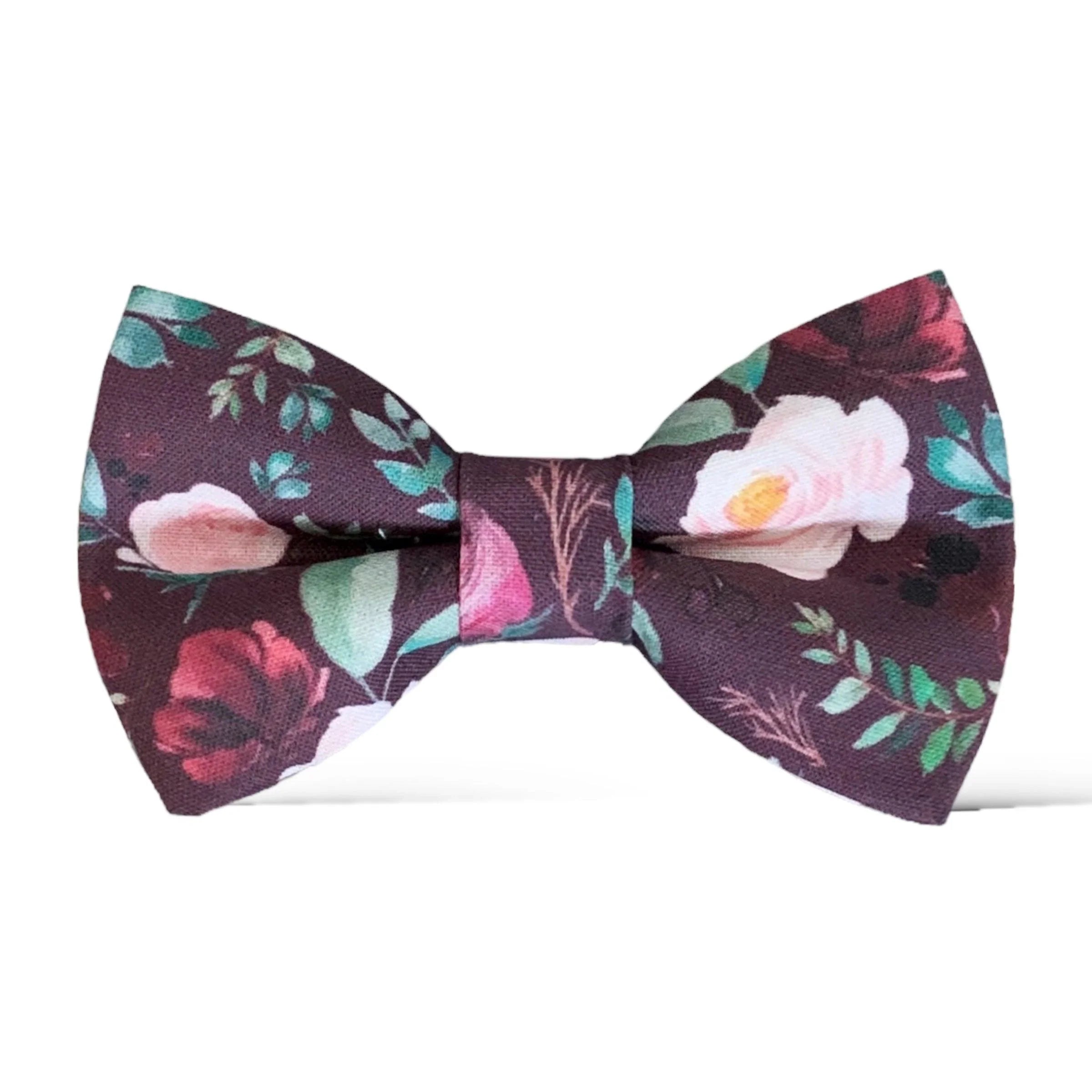 Close up of burgundy floral bow tie with bold blossoms