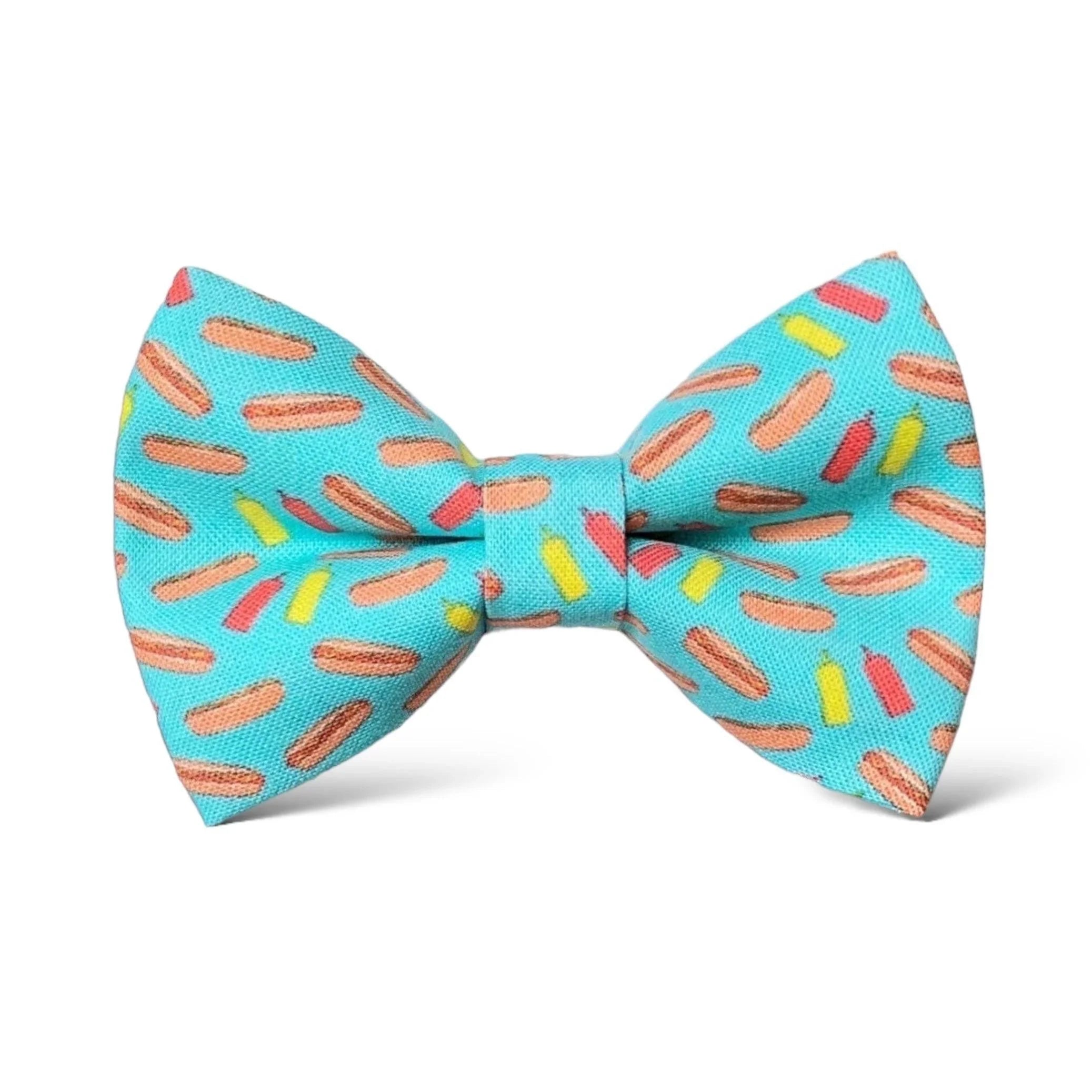 Size chart for pre-tied bow ties from The Bold Bow Tie detailing measurements across three sizes. Small is 3.5 inches wide and recommended for ages 6 months to 5 years. Medium is 4 inches wide and recommended for ages 6 to 12 years. Large is 4.5 inches wide and recommended for ages 13 years and up. Visual icons illustrate the relative sizes with horizontal arrows showing that width is measured from wingtip to wingtip. Bottom text notes that all bow ties are pre-tied and ready to add to your outfit.