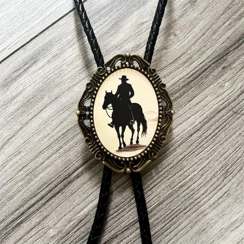 Back of a brass bolo tie with a clamp for the leather cord