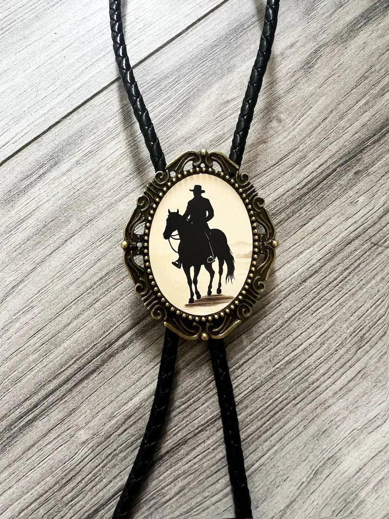 Back of a brass bolo tie with a clamp for the leather cord