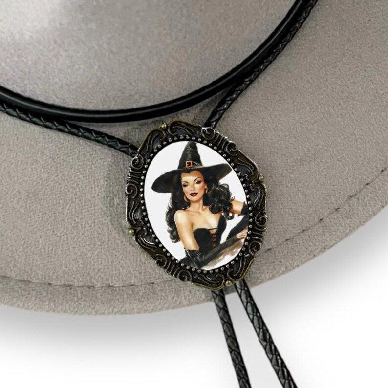 Witchy Bolo Tie featuring a brunette witch in a pointed hat on an oval portrait with an ornate frame.