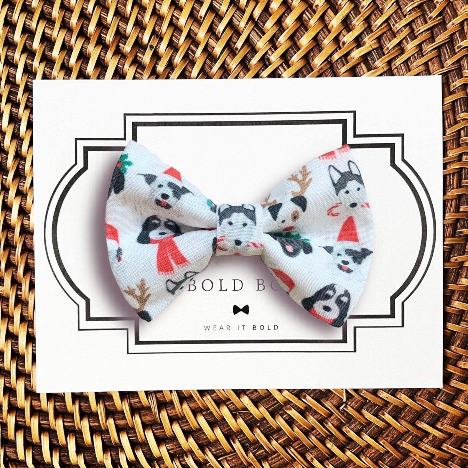 Dog bow tie size chart. Size Small is 3 1/2 inches wide for small dogs under 15 lbs. Size Medium is 4 inches wide for medium dogs between 15 band 40 lbs. Size Large is 4 1/2 inches wide for Large Dogs between 40 band 80 lbs. Size Extra Large is 5 1/2 inches wide for Extra Large Dogs over 80 lbs. Sizing is up to preference and pet bow ties slide on to dog collars with elastic.