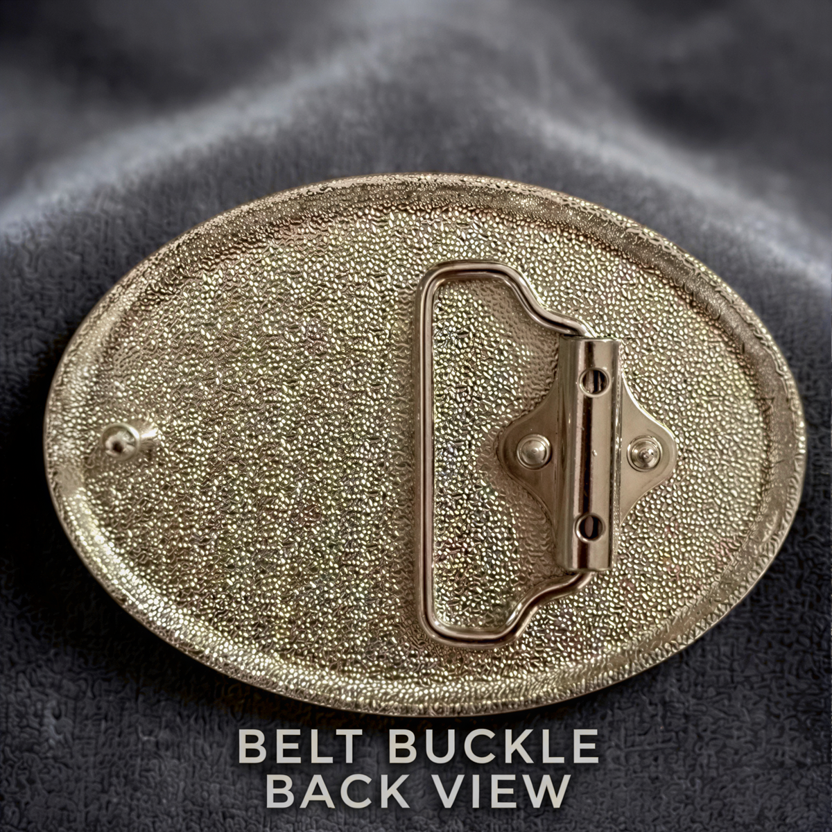 a close-up view of a shiny, metallic belt buckle with a textured surface.