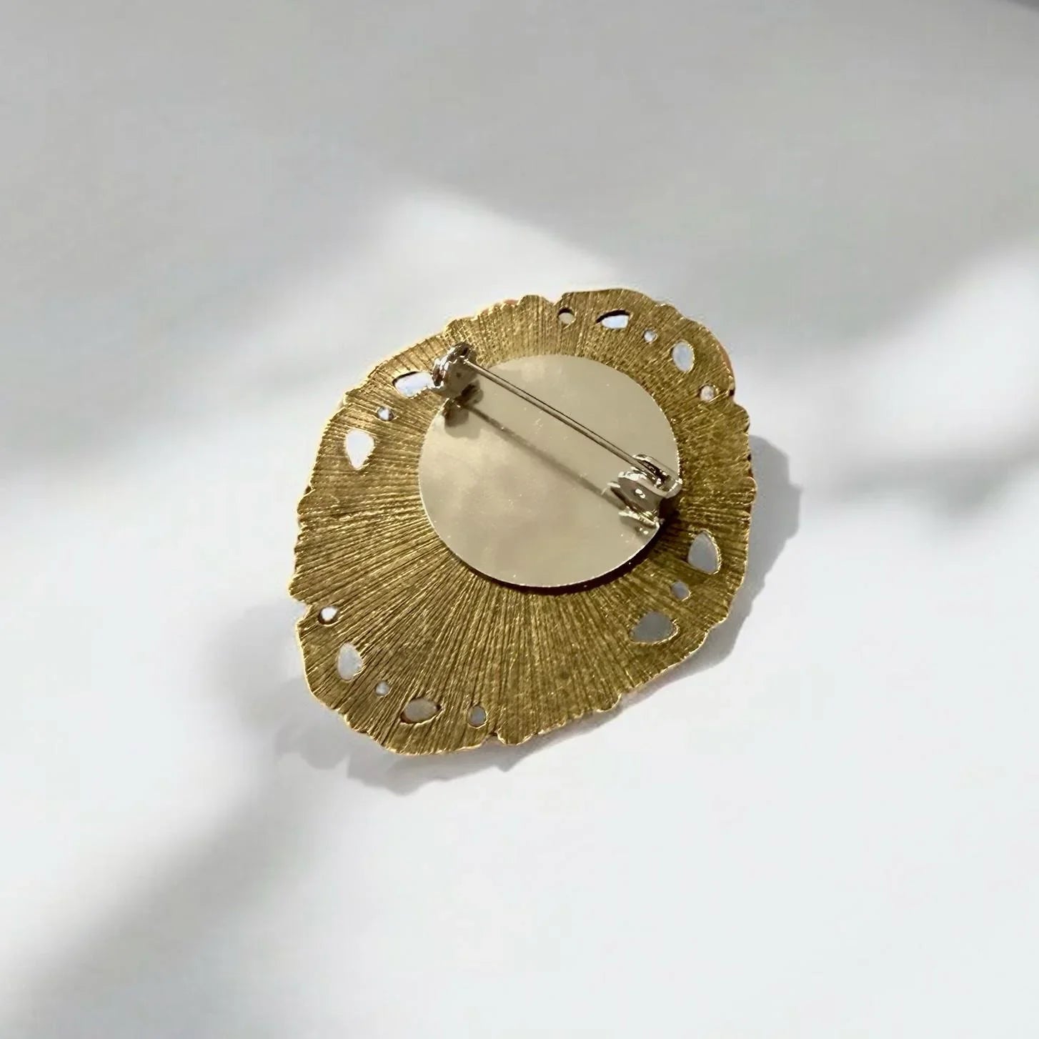 Back of brass victorian style brooch with safety pin attachment