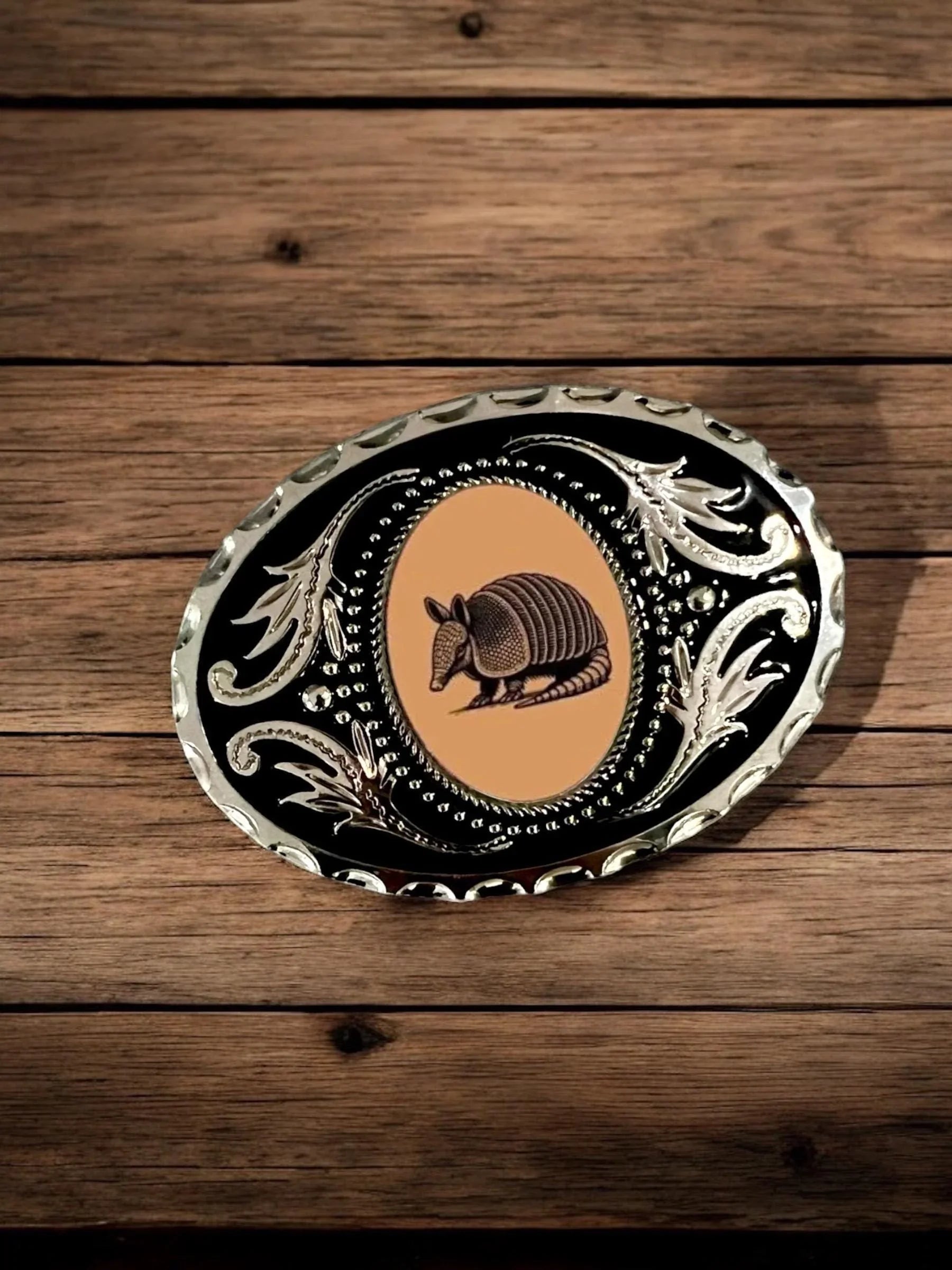 Two options for belt buckles: Option 1 has a leaf pattern and option 2 has flowers on it