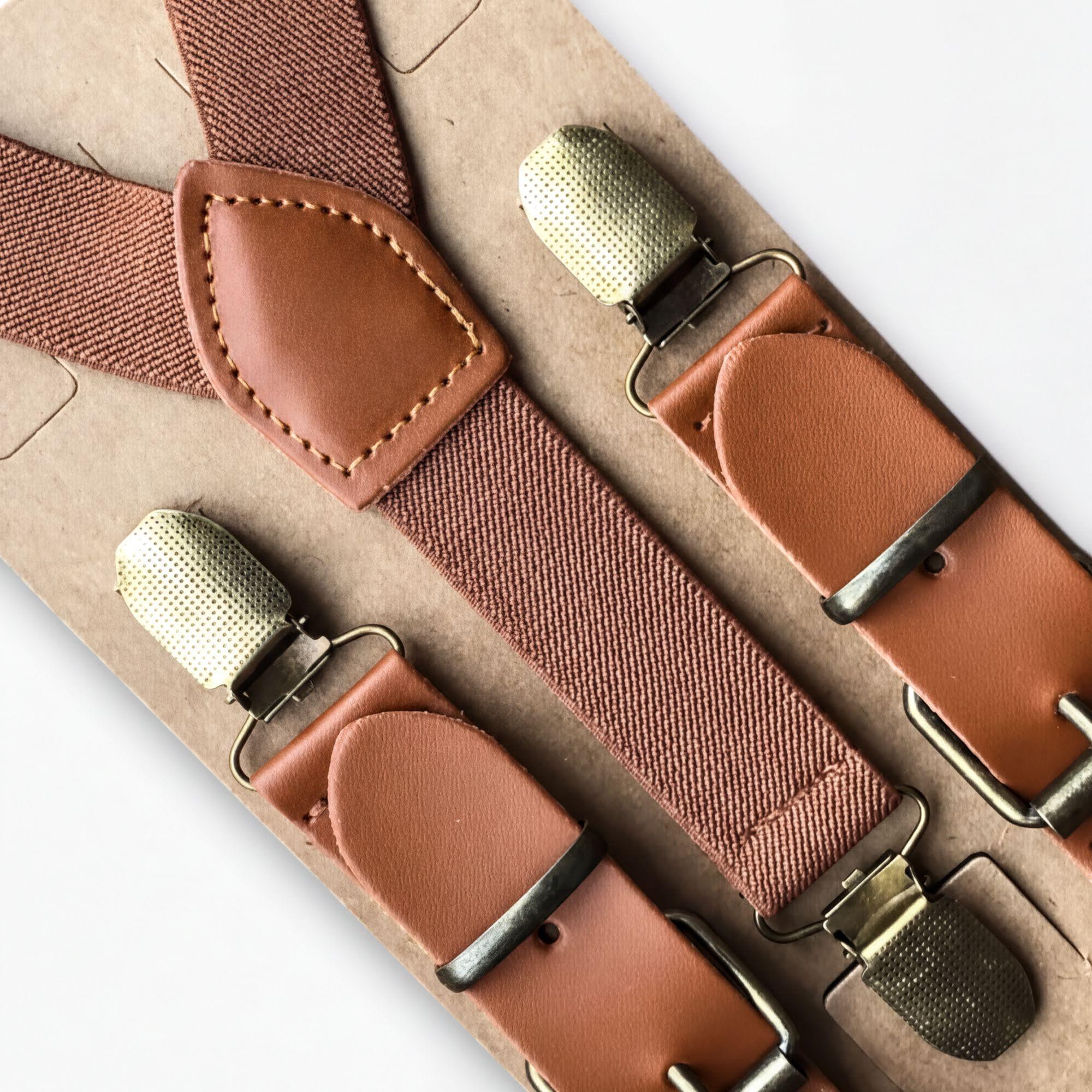 Brown men’s suspenders with bronze clips.