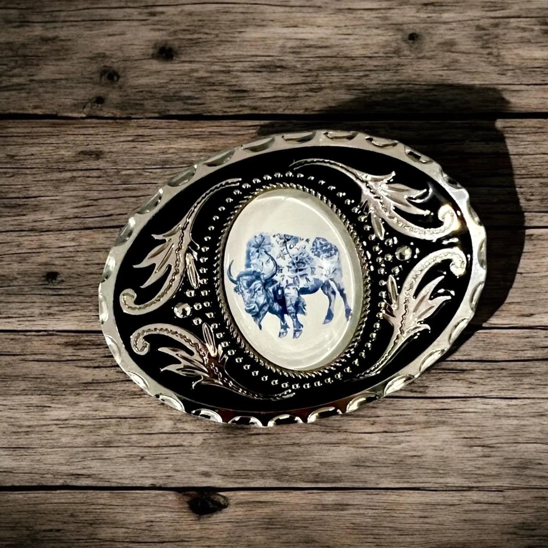 Two options for belt buckles: Option 1 has a leaf pattern and option 2 has flowers on it