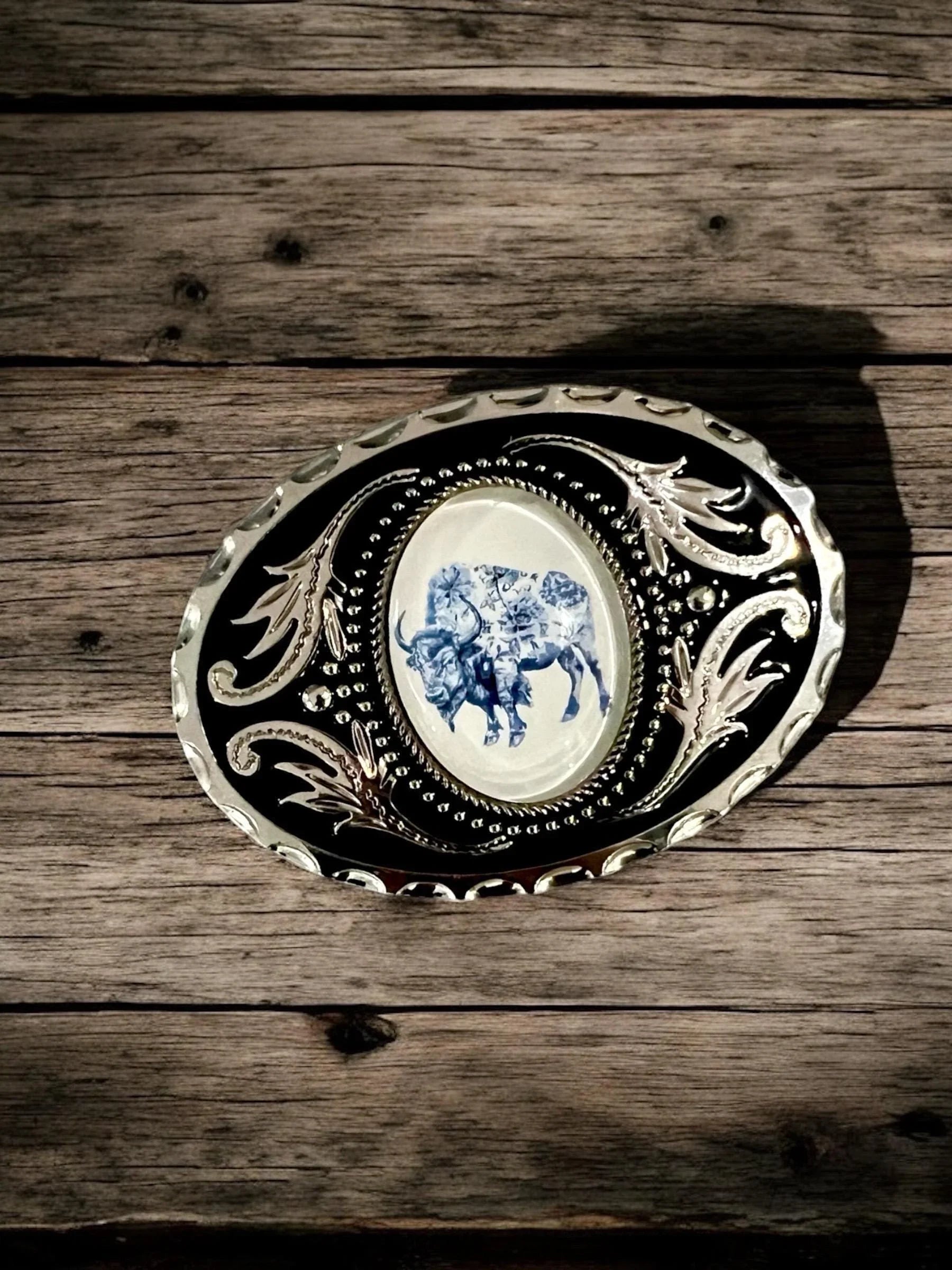 Two options for belt buckles: Option 1 has a leaf pattern and option 2 has flowers on it