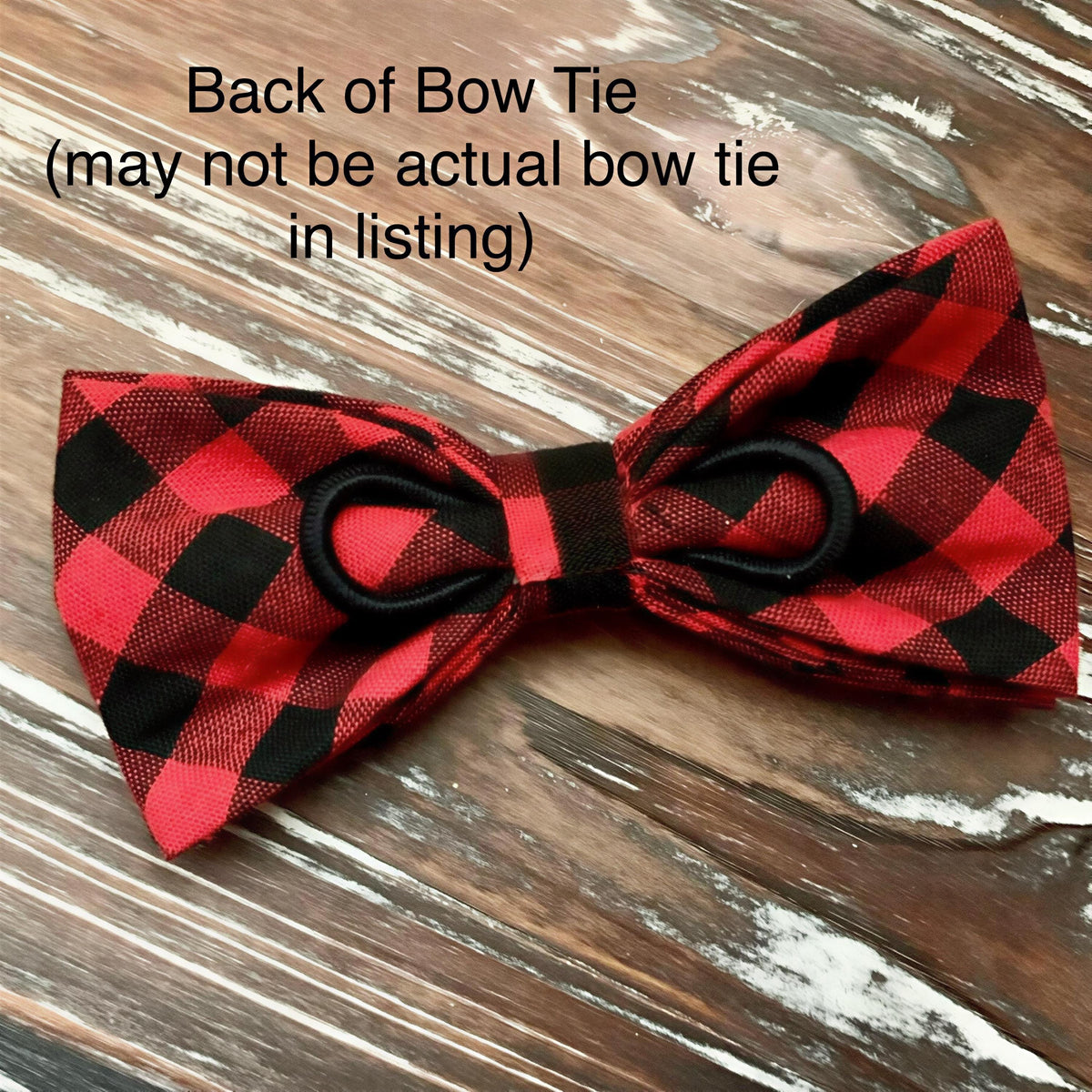 A red and black plaid bow tie is displayed on a wooden surface, with text indicating that it may not be an actual bow tie in a listing.