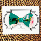 Teal floral bow tie for men for wedding on a white marble counter