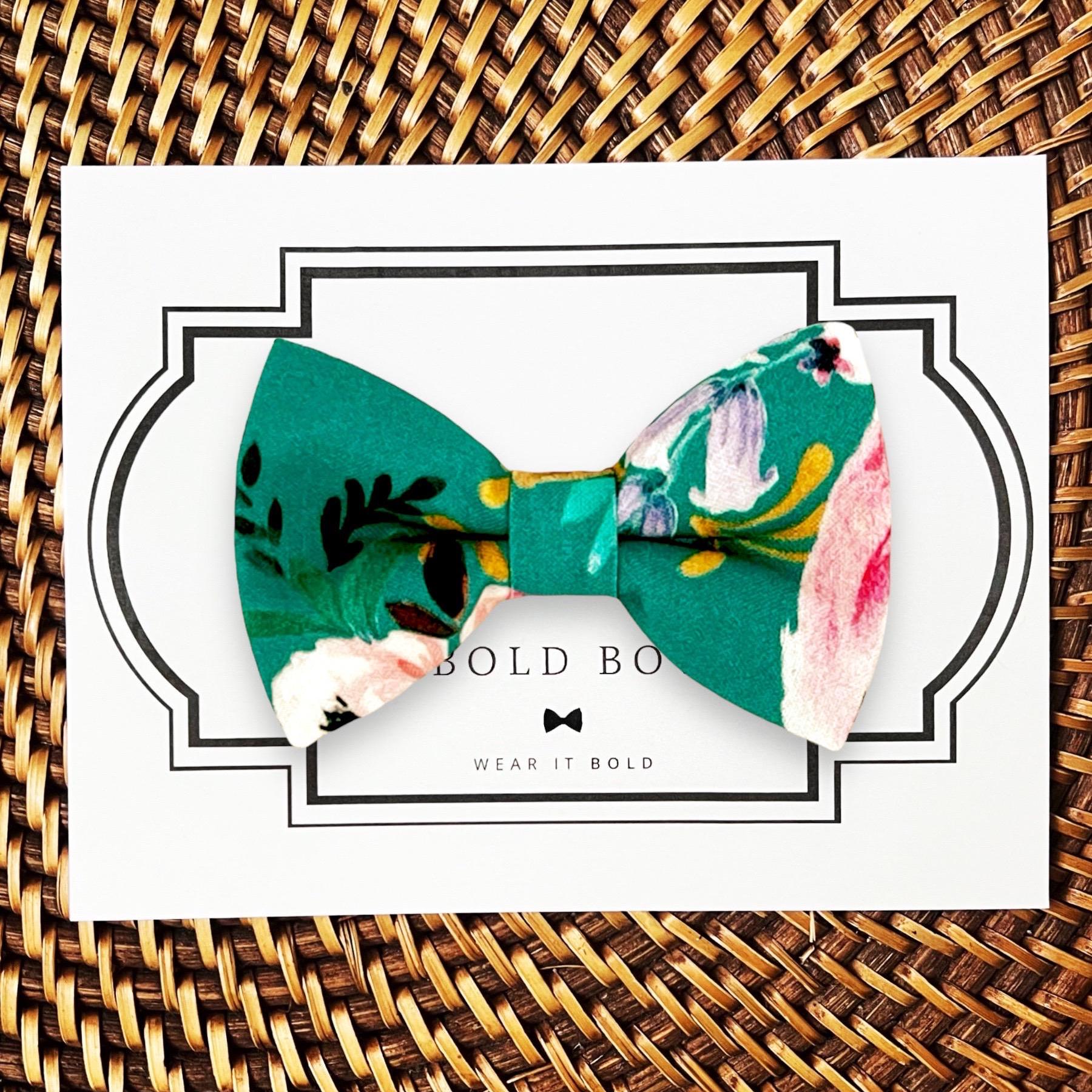 Teal floral bow tie for men for wedding on a white marble counter