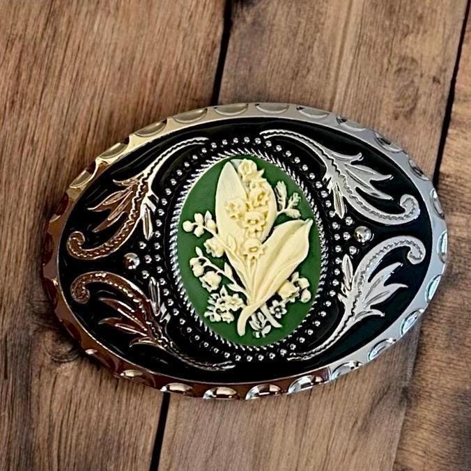 Belt Buckle Cowboy Accessory Lily of the Valley in Green on a wooden table