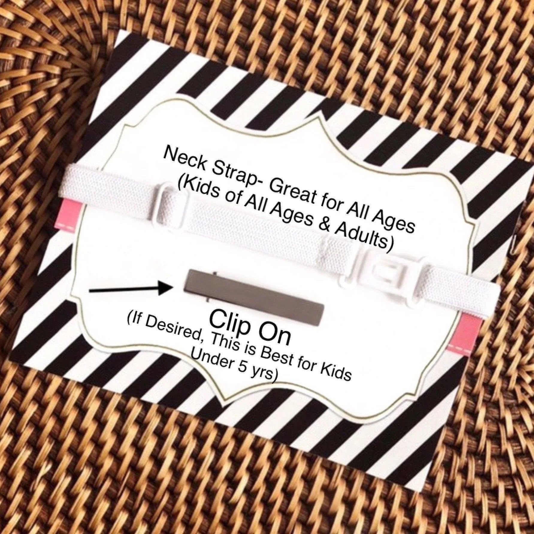 Neck strap packaging on a black and white striped card with a pale pink tab