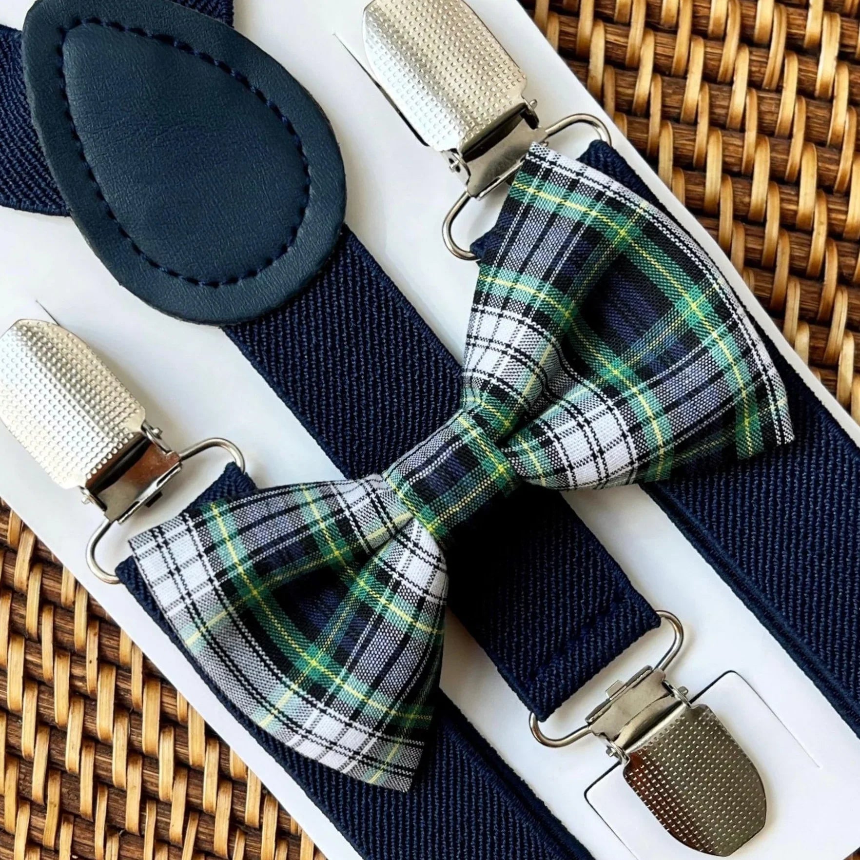 Plaid bow tie and suspenders in navy green and white.