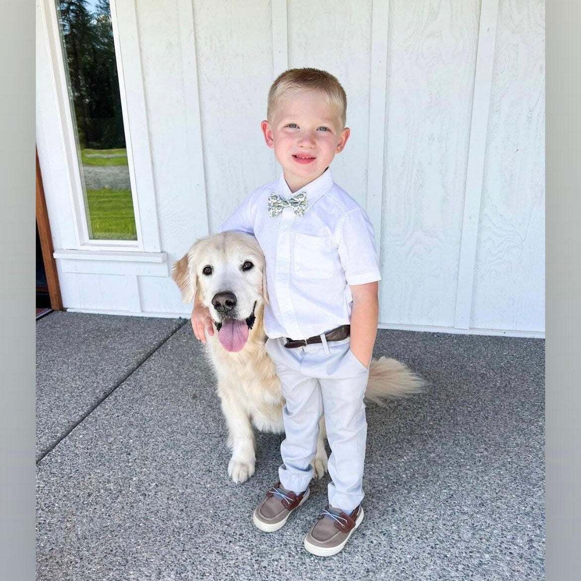 Ring bearer in dinosaur bow tie worn