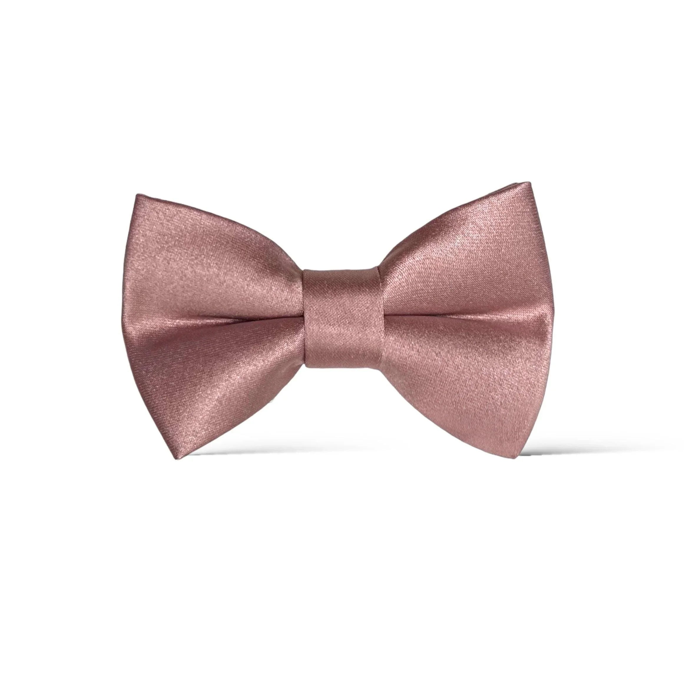 Size chart for pre-tied bow ties from The Bold Bow Tie detailing measurements across three sizes. Small is 3.5 inches wide and recommended for ages 6 months to 5 years. Medium is 4 inches wide and recommended for ages 6 to 12 years. Large is 4.5 inches wide and recommended for ages 13 years and up. Visual icons illustrate the relative sizes with horizontal arrows showing that width is measured from wingtip to wingtip. Bottom text notes that all bow ties are pre-tied and ready to add to your outfit.