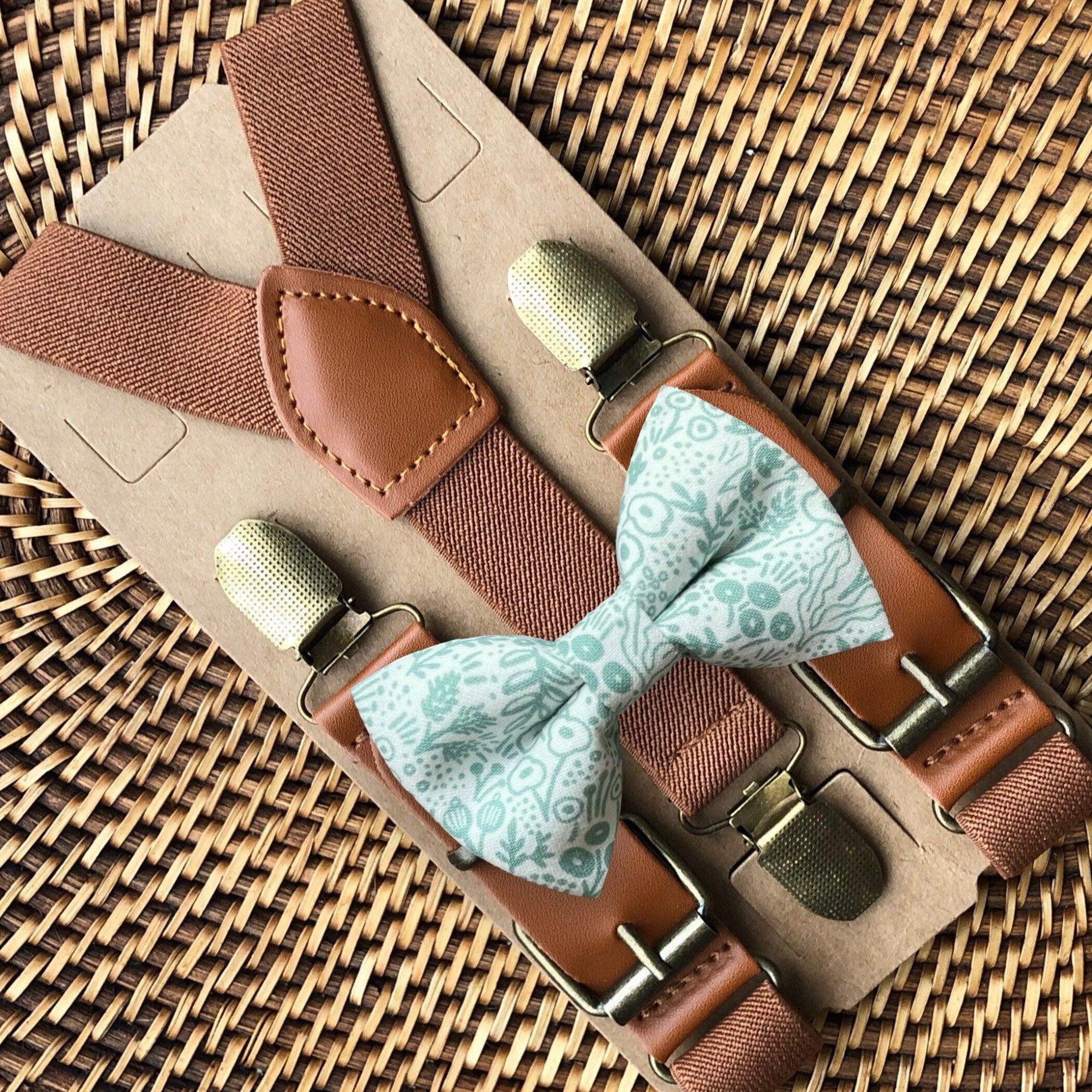 Sage Rosettes bow tie with cognac buckle suspenders displayed on a kraft background