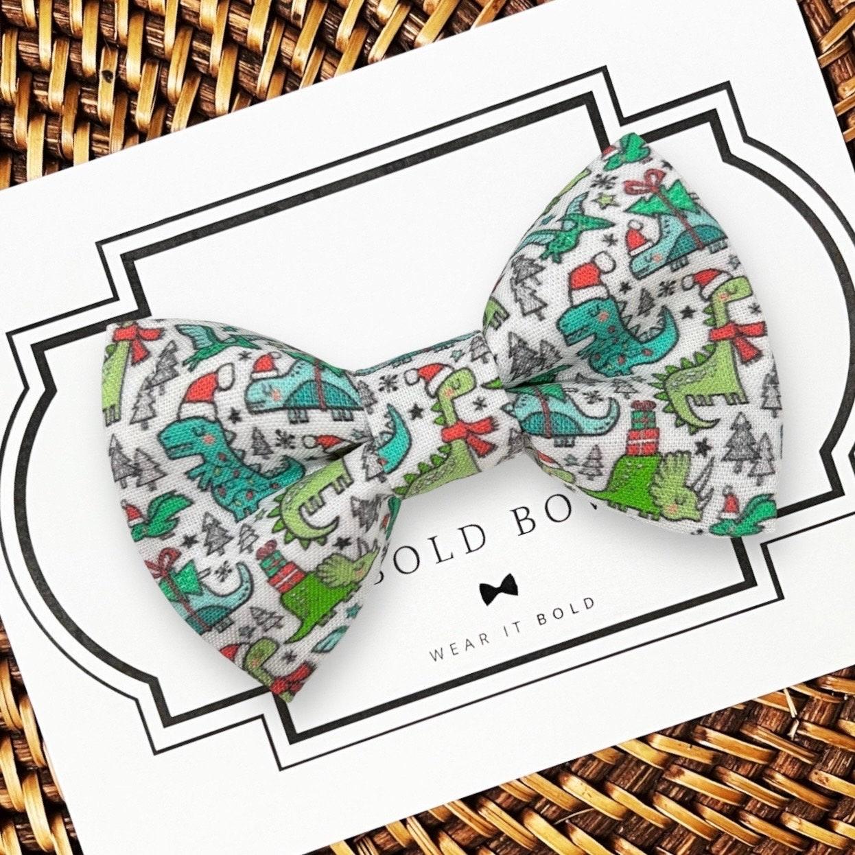 dinosaur Christmas dog bow tie on a white card.