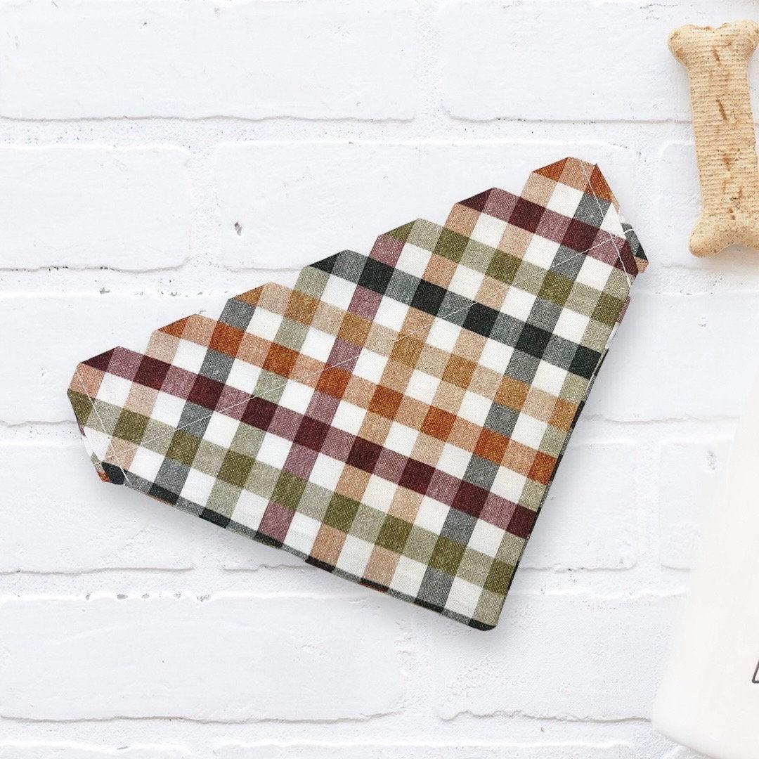Fluffy tan dog wearing a handmade Stud Muffin dog bandana from The Bold Bow Tie, with product features including handmade design, comfortable collar slide-on fit, high-quality fabric, and sizes for all breeds.
