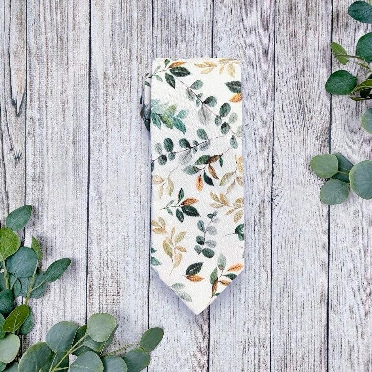 Groomsmen ties with floral print in sage green and gold.