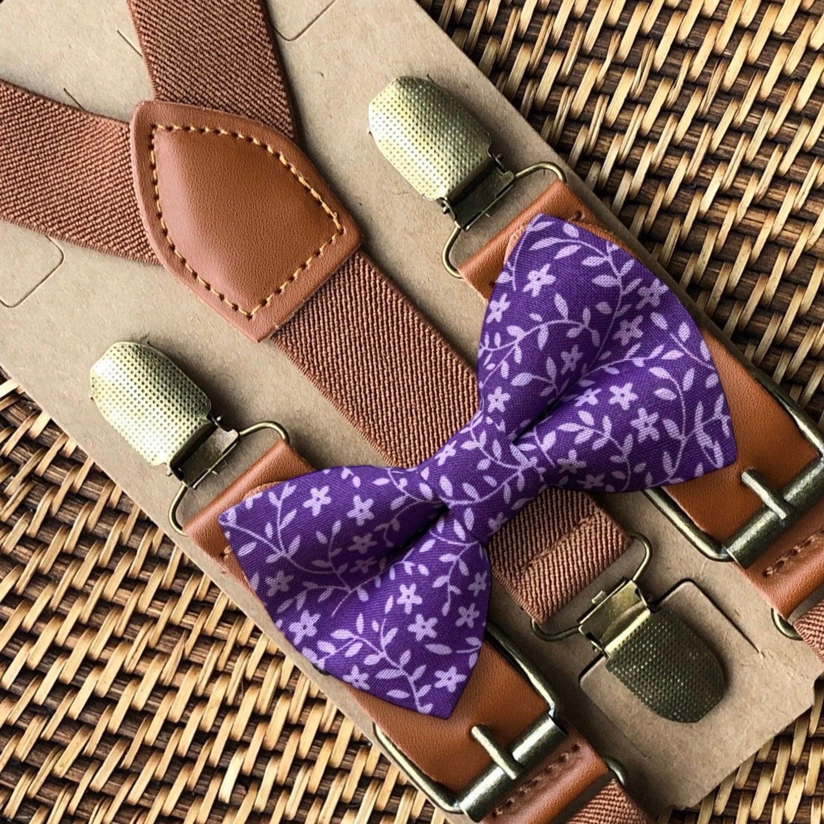 Purple floral bow tie paired with cognac brown leather suspenders and metal buckles.