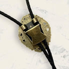 Back of bronze bolo tie clasp with black leather cord