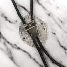 Silver bolo clasp with black leather cord