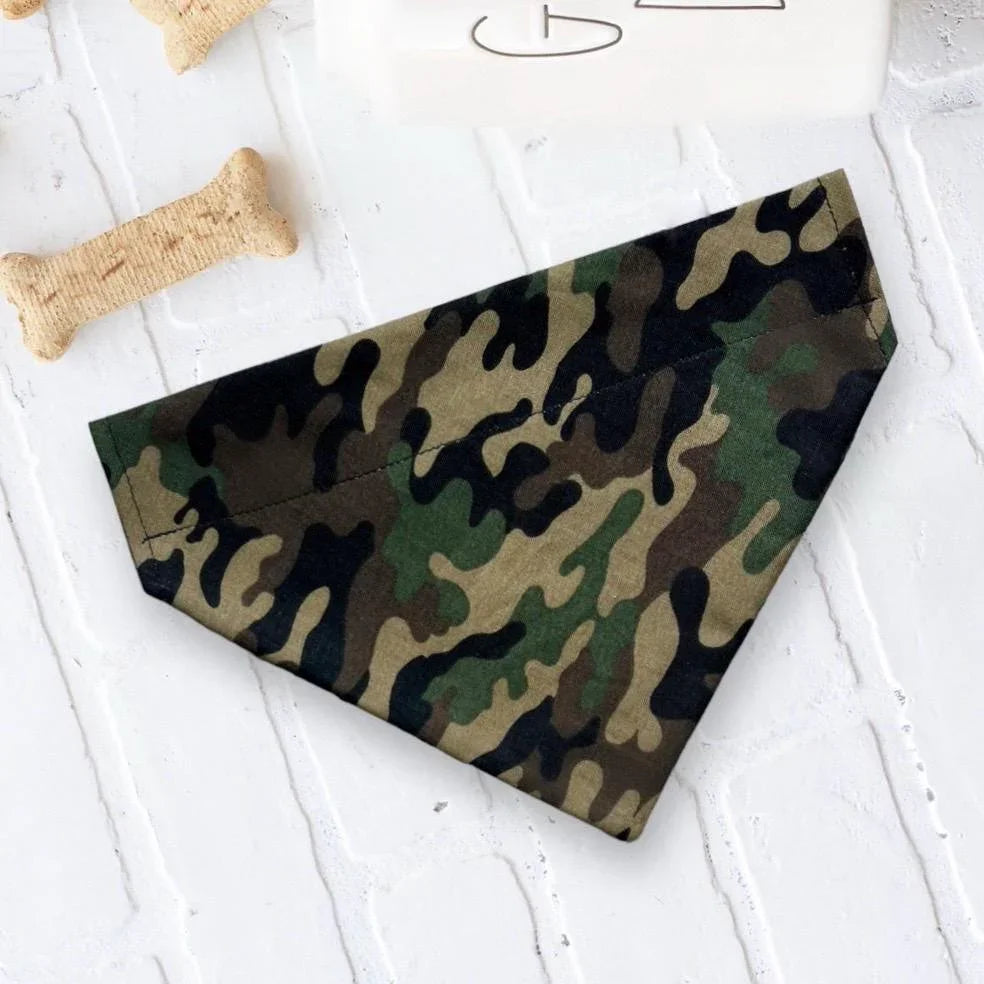 Green camouflage dog bandana laid flat on a white surface