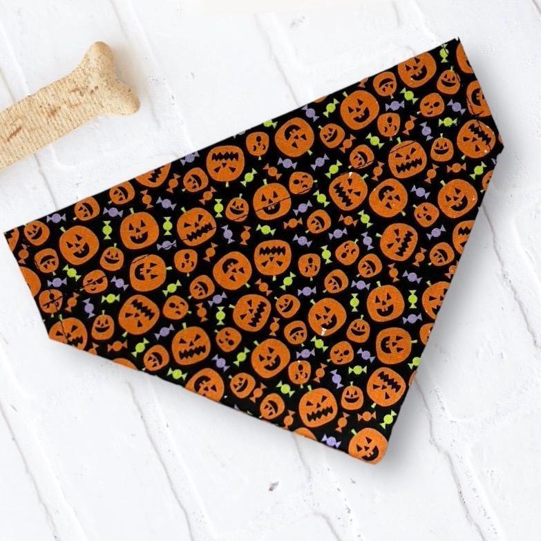Black Halloween pumpkin bandana for dogs or cats with orange pumpkins and candy accents