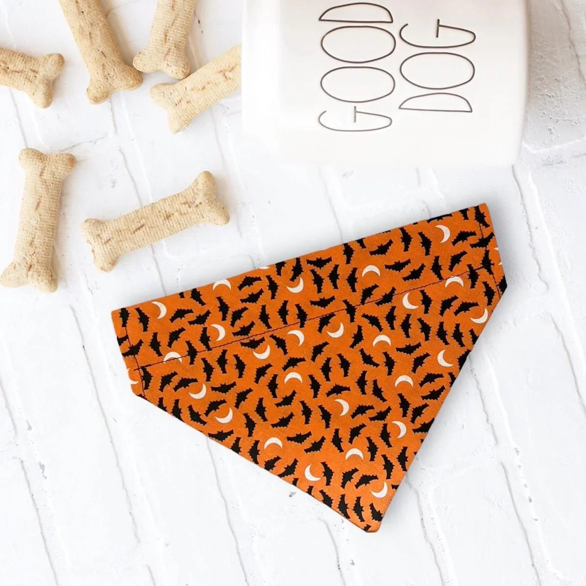 Size chart for dog bandanas from The Bold Bow Tie detailing measurements for Small, Medium, Large, and X-Large sizes. Small fits neck sizes 11 to 13 inches with a width of 7 inches and length of 5 inches. Medium fits neck sizes 13 to 16 inches with a width of 9 inches and length of 6 inches. Large fits neck sizes 16 to 21 inches with a width of 11 inches and length of 8 inches. X-Large fits neck sizes 21 to 25 inches with a width of 13 inches and length of 9 inches.