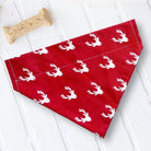 Red bandana with white deer pattern on a white wooden surface