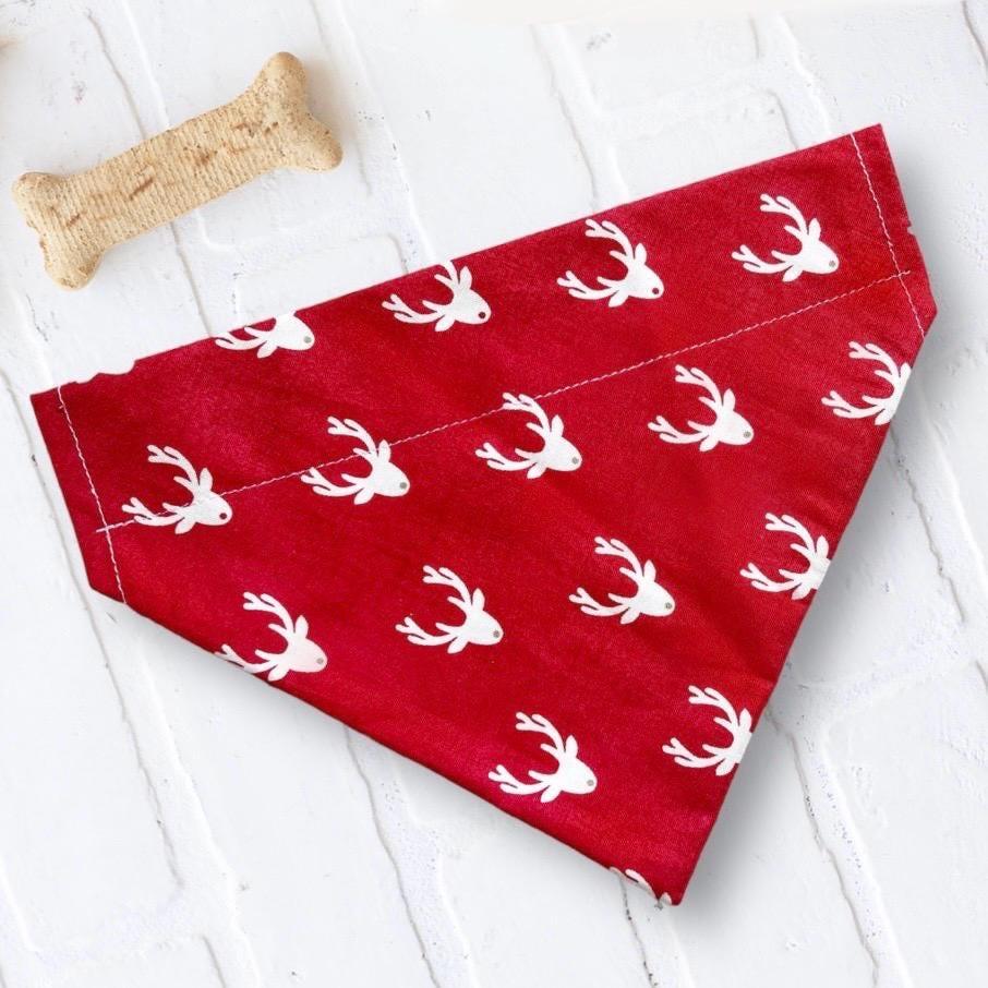 Red bandana with white deer pattern on a white wooden surface