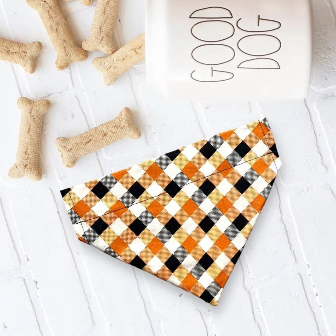 Size chart for dog bandanas from The Bold Bow Tie detailing measurements for Small, Medium, Large, and X-Large sizes. Small fits neck sizes 11 to 13 inches with a width of 7 inches and length of 5 inches. Medium fits neck sizes 13 to 16 inches with a width of 9 inches and length of 6 inches. Large fits neck sizes 16 to 21 inches with a width of 11 inches and length of 8 inches. X-Large fits neck sizes 21 to 25 inches with a width of 13 inches and length of 9 inches.