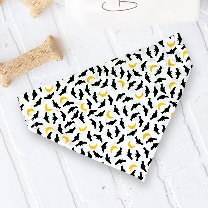 White Halloween bandana fabric with black bats and yellow moons pattern