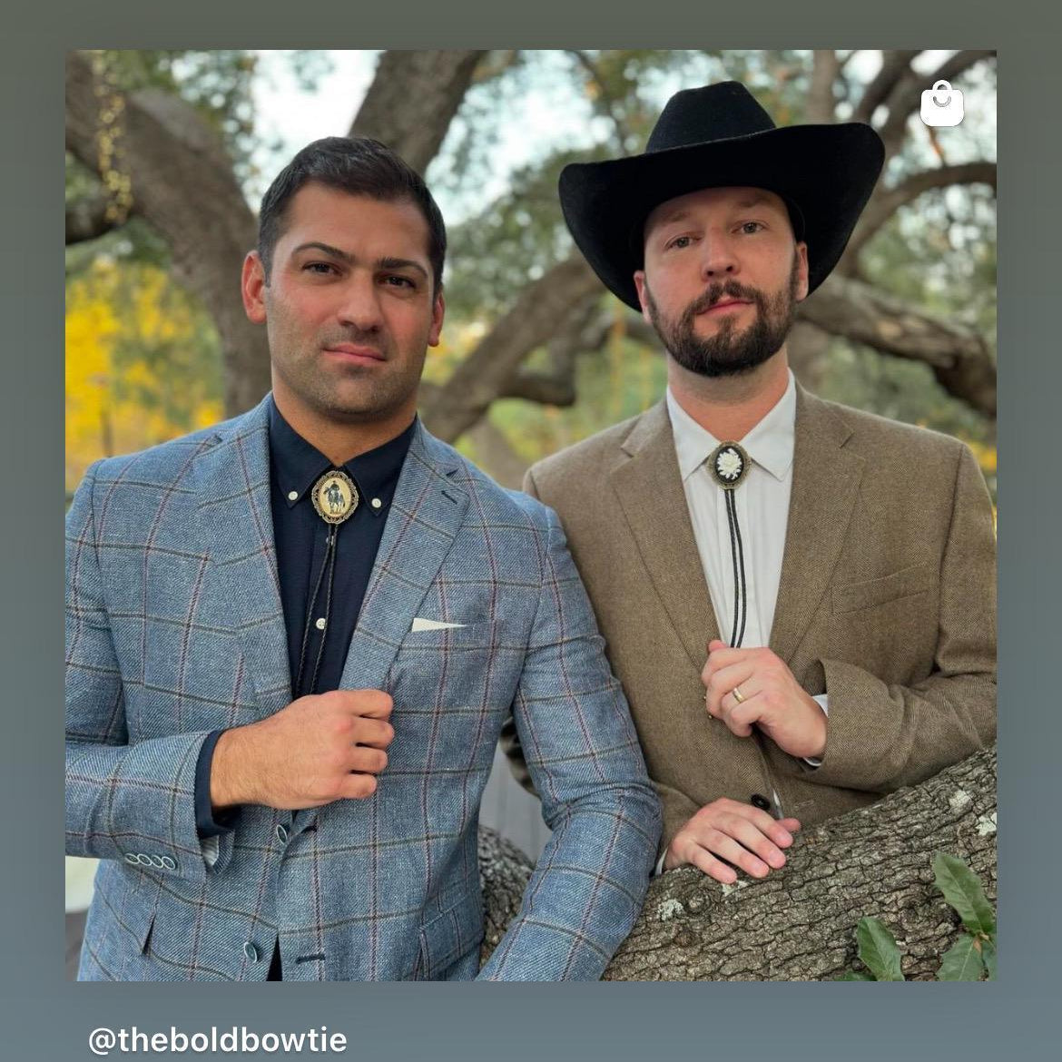Two men in western attire modeling bolo ties; one in a blue plaid suit and the other in a tan blazer with a black cowboy hat.