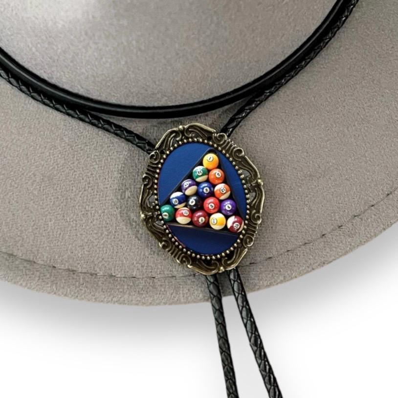 Close-up of billiard ball pool pendant on a black braided bolo tie cord.