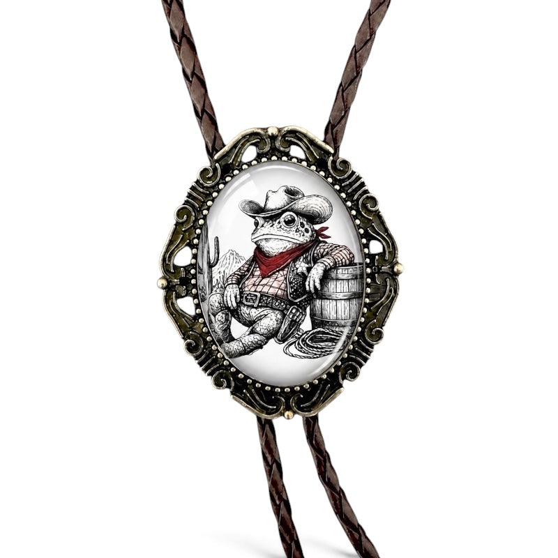 The Bold Bow Tie western bolo tie featuring a cowboy toad illustration in an ornate brass scalloped bezel on leather