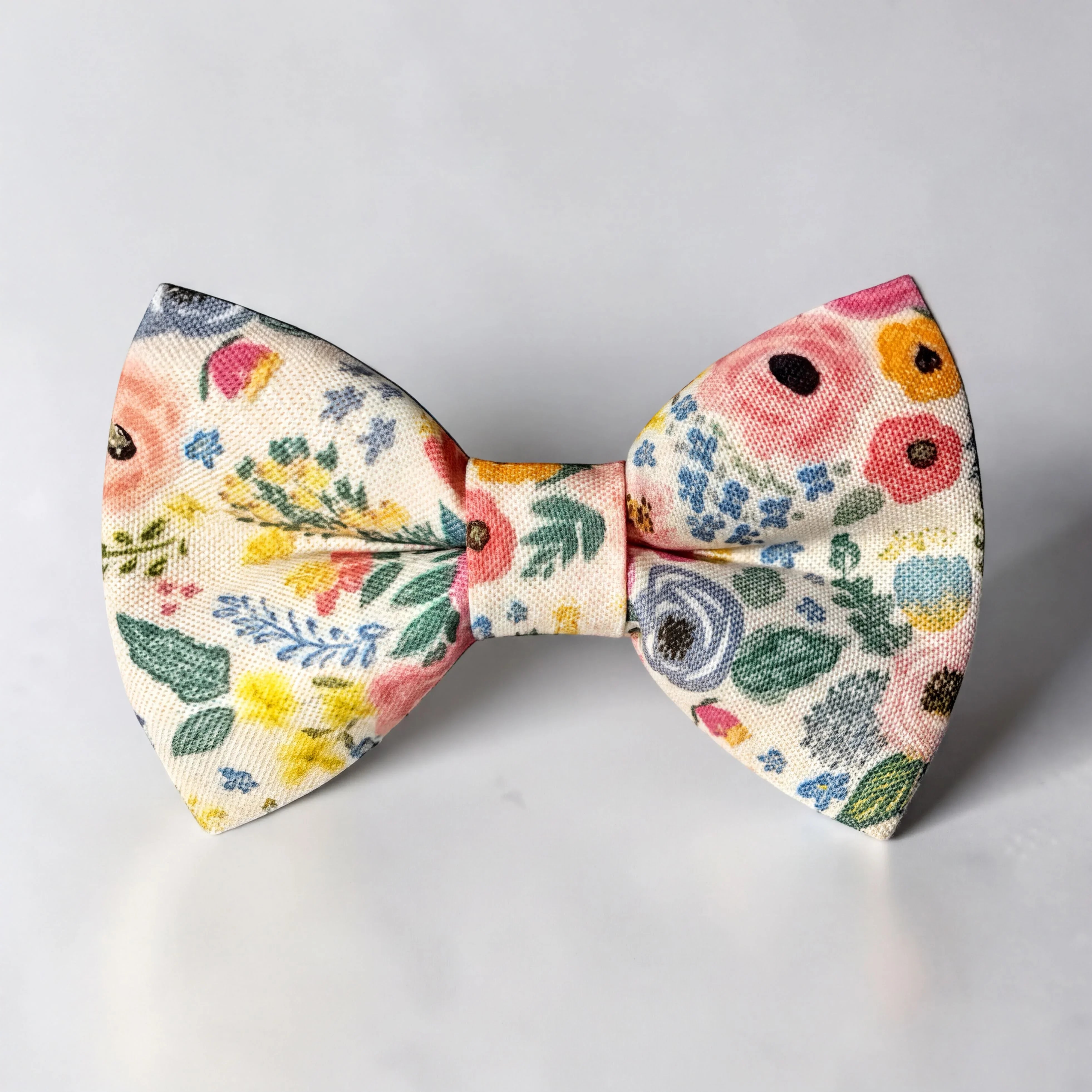 The Bold Bow Tie pre-tied floral cotton bow tie with colorful flowers on a cream background for weddings.