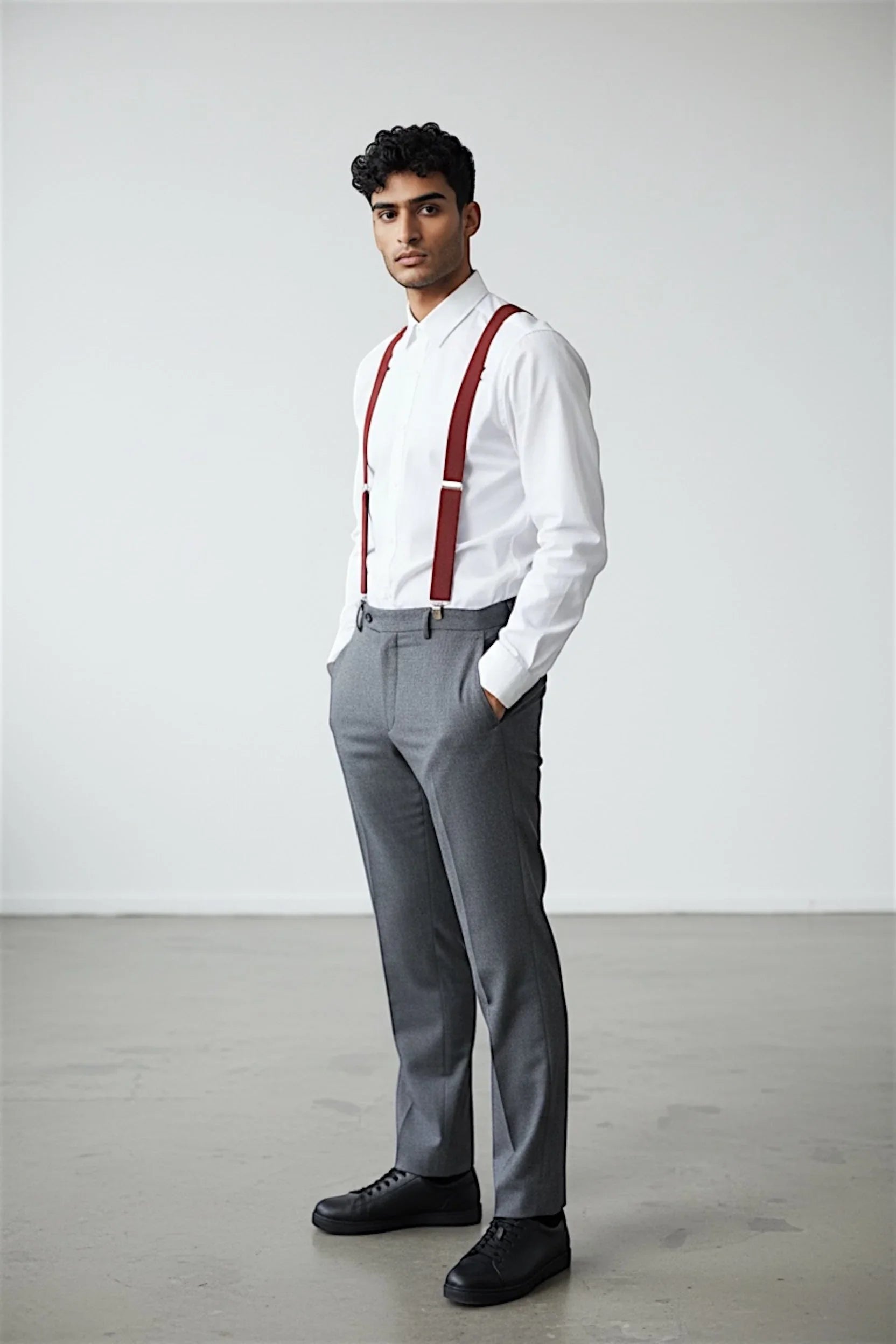 Mens burnt orange suspenders for men on groomsman in a white shirt and gray pants for a wedding.