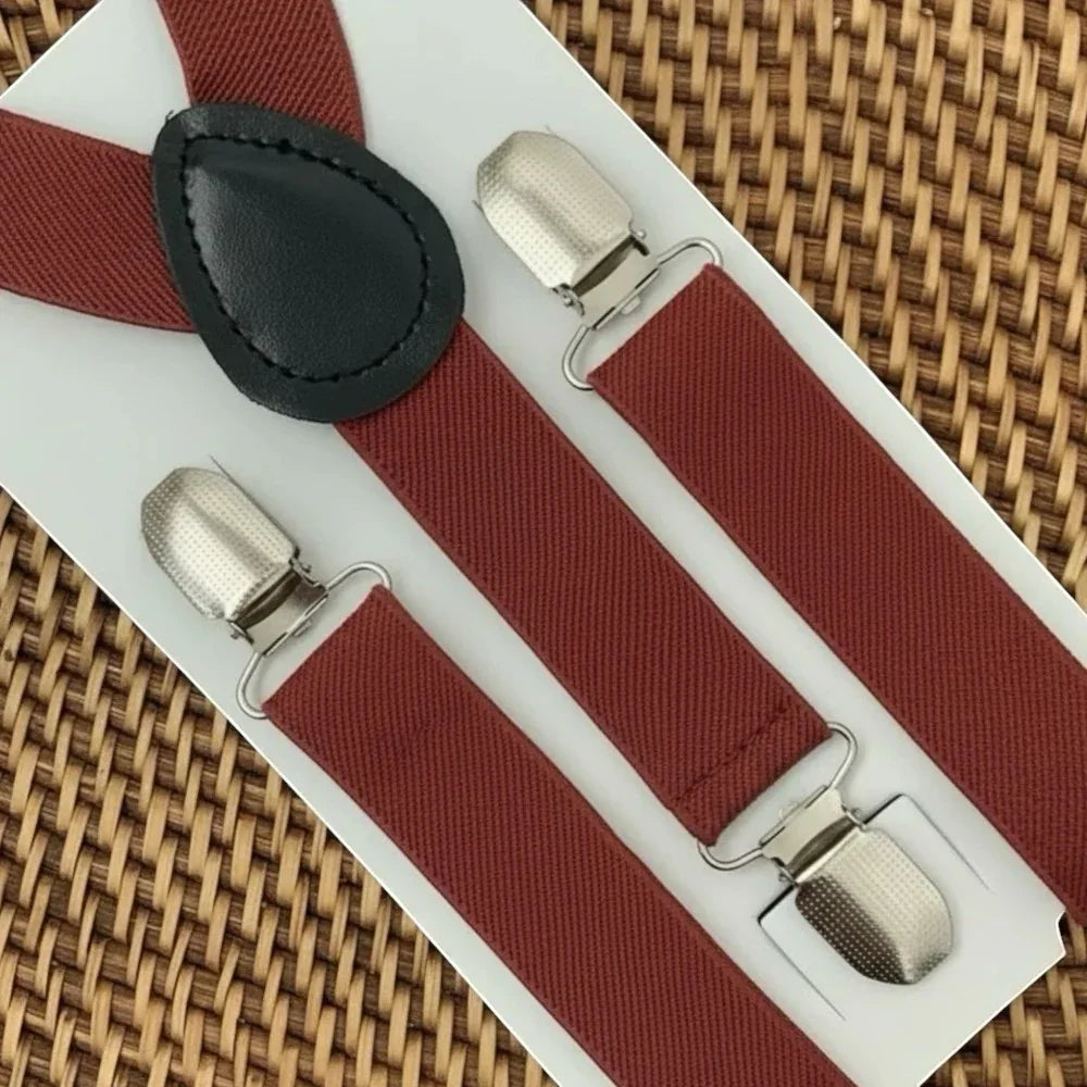 The Bold Bow Tie terracotta wedding suspenders with silver metal clips and a black leather back patch on display.