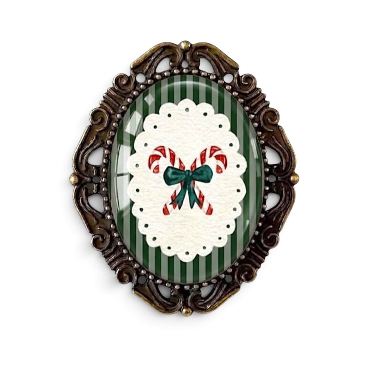 The Bold Bow Tie vintage-style Christmas brooch featuring candy canes on a green striped background in a bronze frame.
