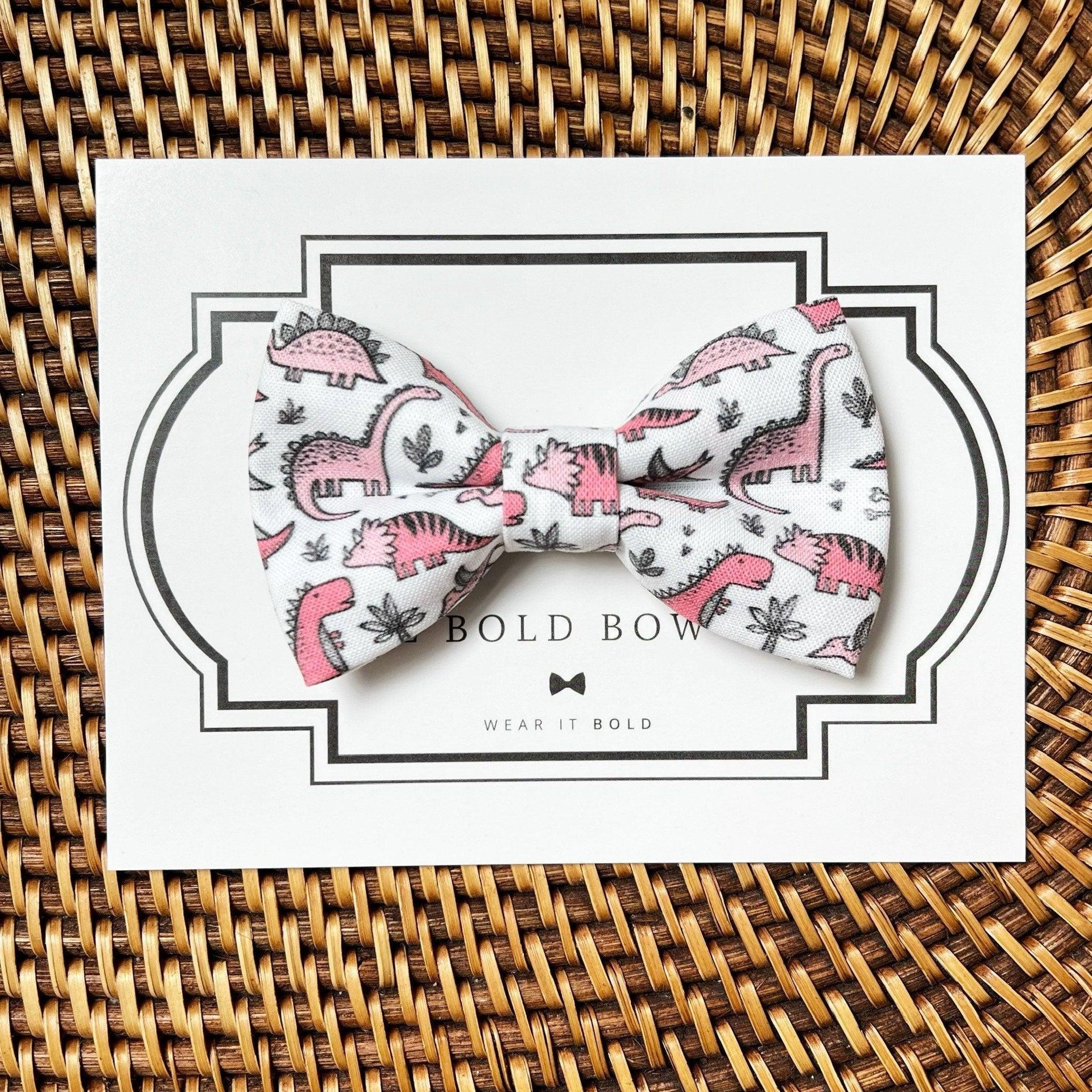 Colorful floral bow on a white card with striped border packaging from The Bold Bow Tie LLC