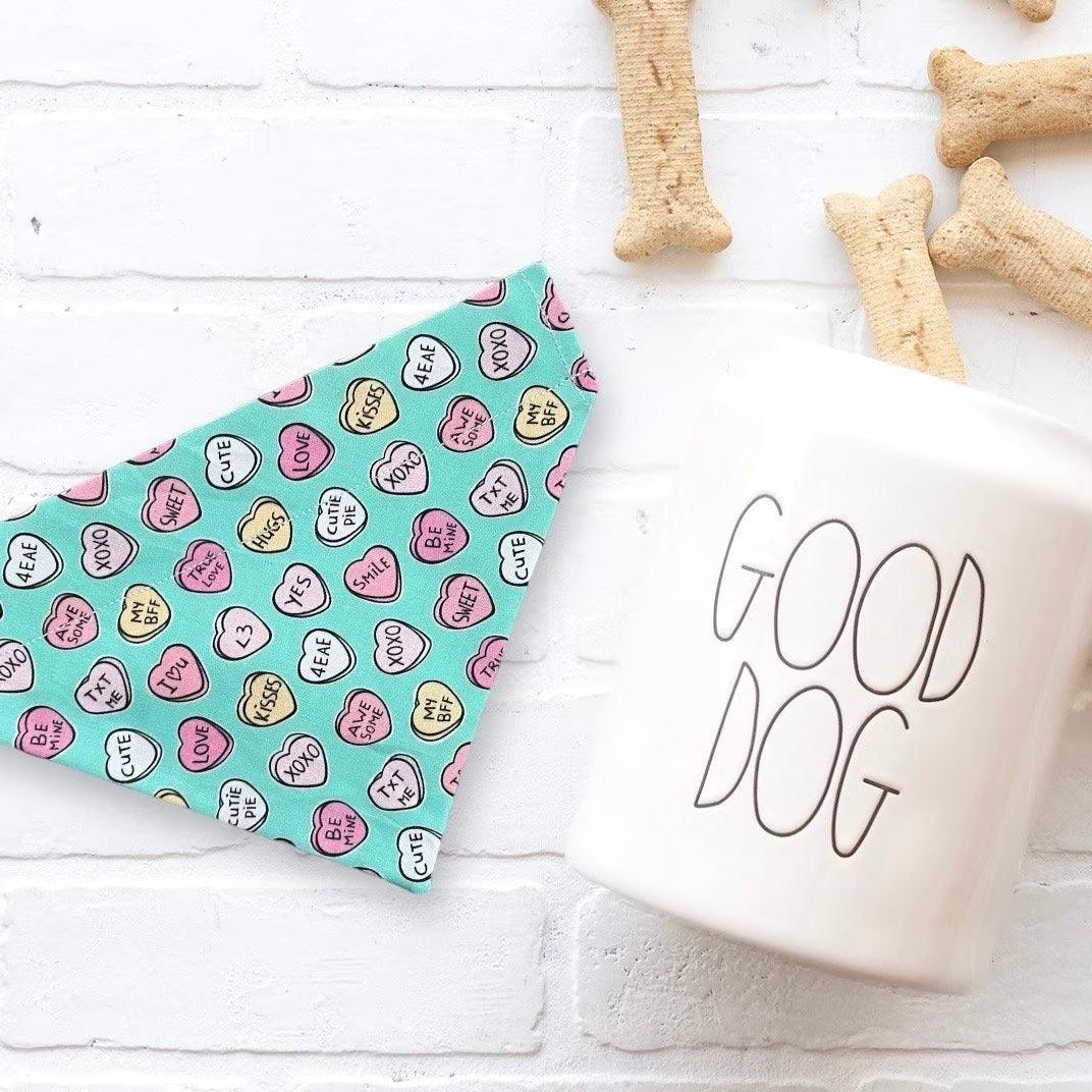 a cup of coffee next to some dog treats