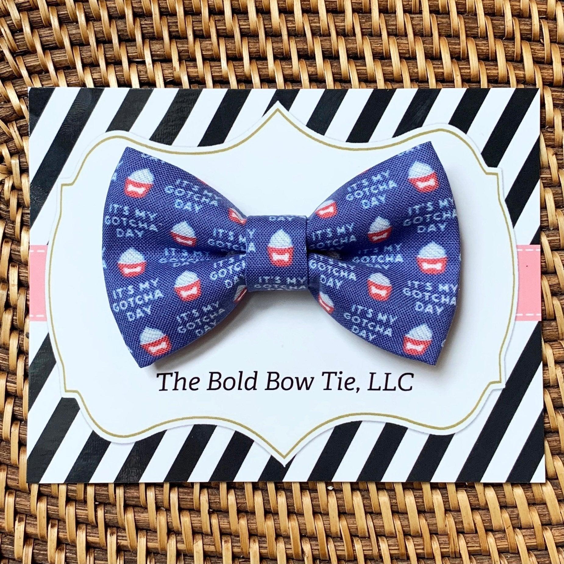 Vibrant cassette tape bow tie on striped black and white packaging with The Bold Bow Tie LLC text