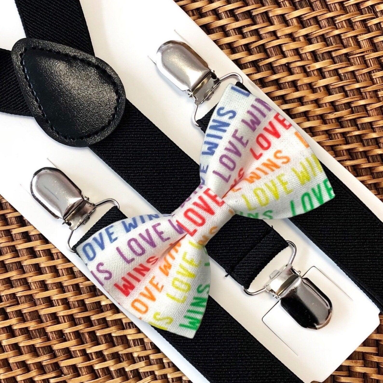 Bow tie with 'Love Wins' text on a white background with black suspenders for gay pride and LGBTQ pride.