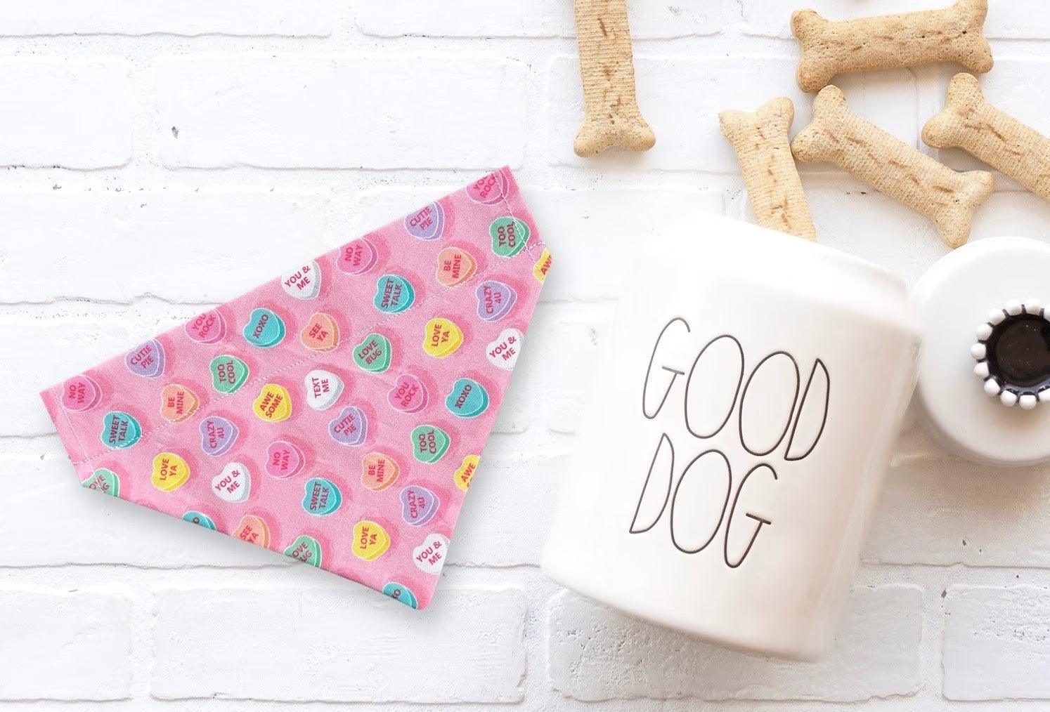Valentine’s Day dog bandana accessory next to some dog treats