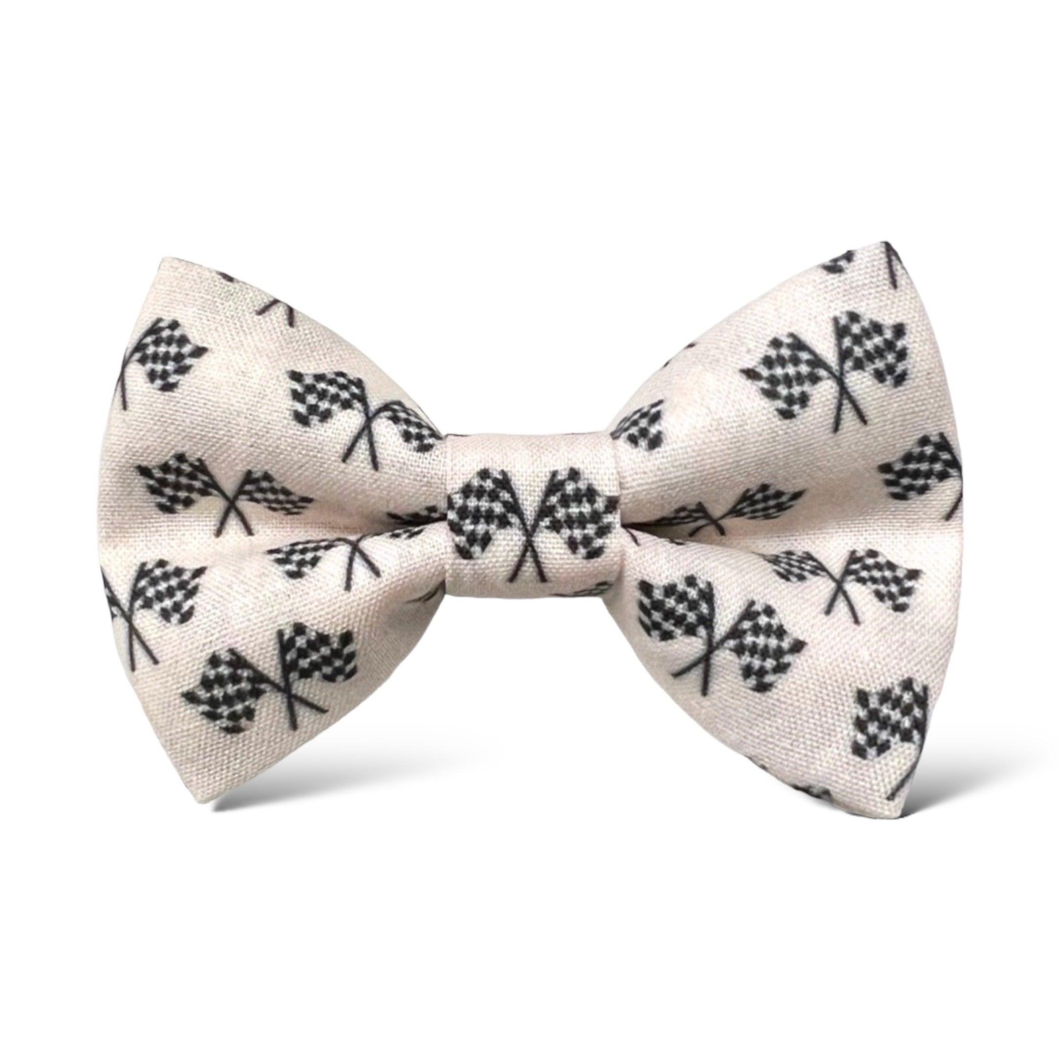 A beige bow tie with a pattern of black checkered flags.