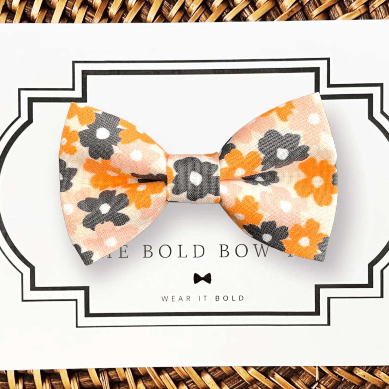 Orange floral gray and cream pet bow tie displayed on a white card with a decorative black border